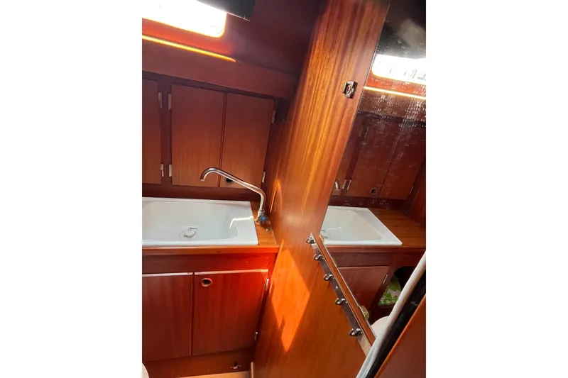 Slide: The Image of Interior of 1984 Vindo 34 yacht featuring wooden cabinetry and a sink. - 12