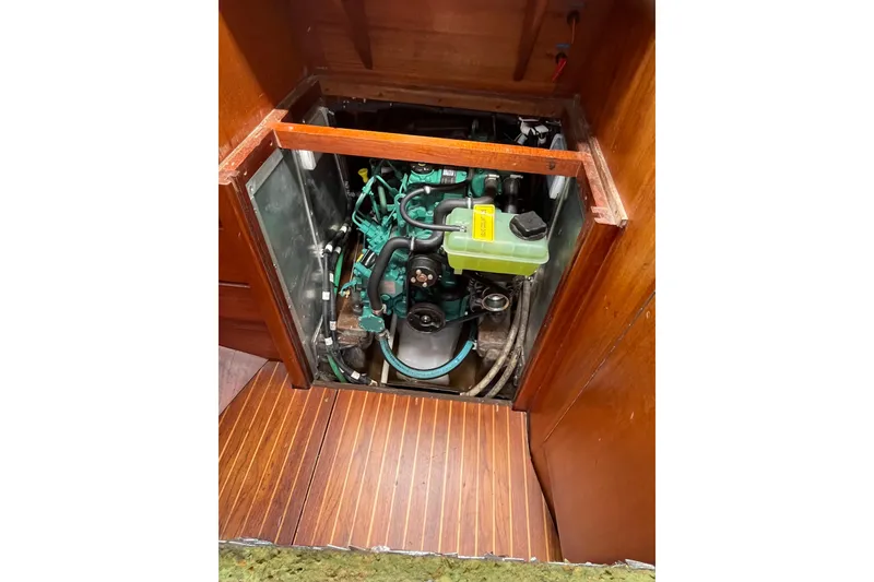 Slide: The Image of Engine compartment of a 1984 Vindo 34 sailboat, featuring a green engine. - 14