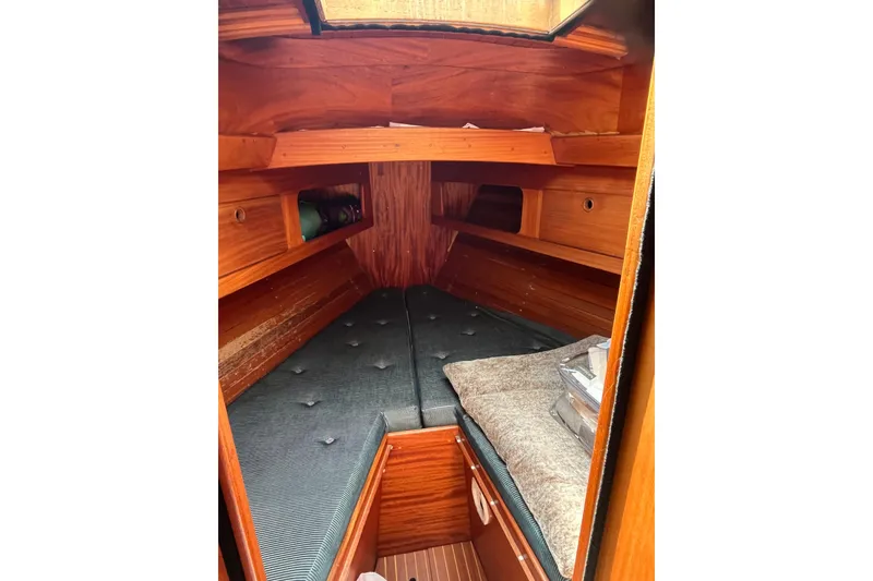 Slide: The Image of Cozy cabin interior of 1984 Vindo 34 sailboat with wooden finish and cushioned berth. - 10
