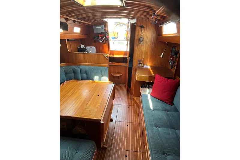 Slide: The Image of Interior of 1984 Vindo 34 sailboat with wooden furnishings and blue seating. - 5