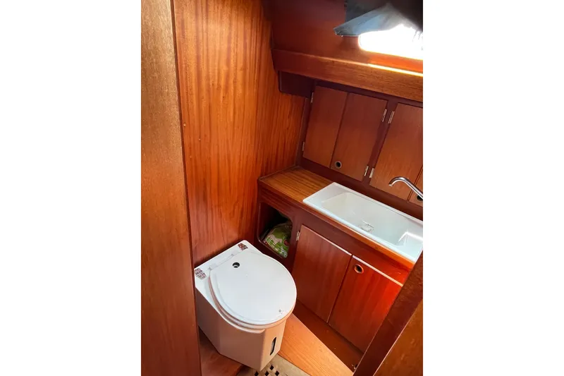 Slide: The Image of Wooden interior of 1984 Vindo 34 yacht bathroom with sink and toilet. - 11