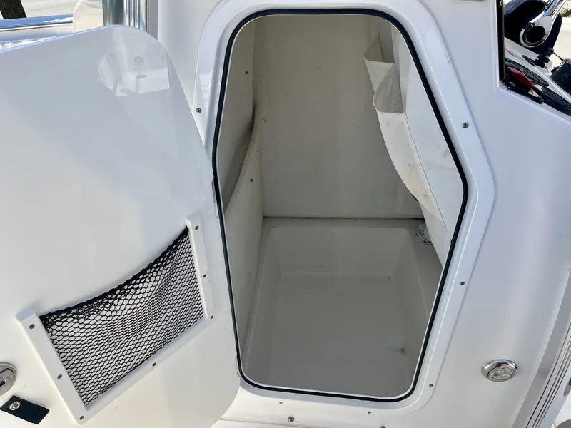 Slide: The Image of The image shows a storage compartment or cabin on a 2022 Sea Hunt Ultra 234 boat. - 22