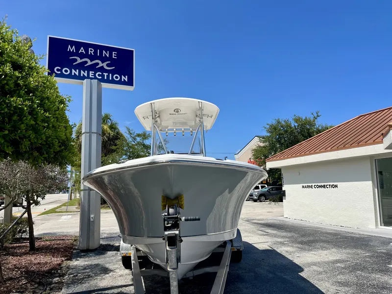 Slide: The Image of Sea Hunt Ultra 234 boat from 2022 in front of a Marine Connection building. - 3