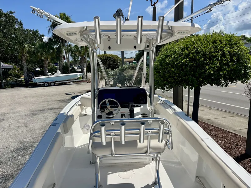 Slide: The Image of A 2022 Sea Hunt Ultra 234 boat with a modern helm and fishing rod holders. - 9