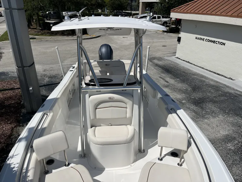 Slide: The Image of The image shows a 2022 Sea Hunt Ultra 234 boat with white seating and a T-top. - 18