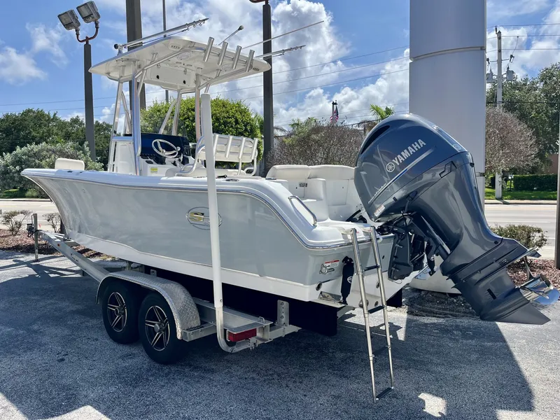 Slide: The Image of A 2022 Sea Hunt Ultra 234 boat on a trailer, featuring a Yamaha outboard motor. - 4