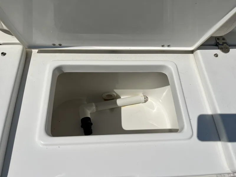 Slide: The Image of An open storage compartment on a 2022 Sea Hunt Ultra 234 boat. - 23
