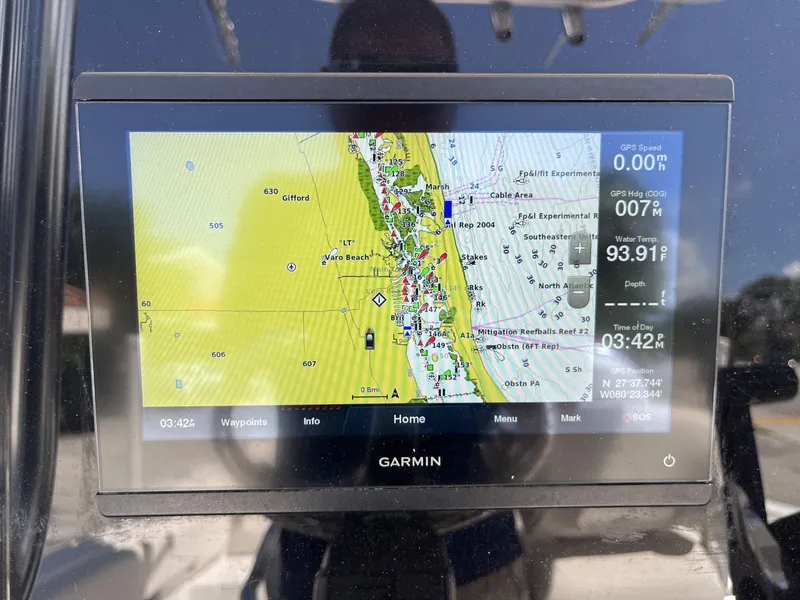 Slide: The Image of A Garmin navigation system displays a nautical chart with details on position and speed. - 13