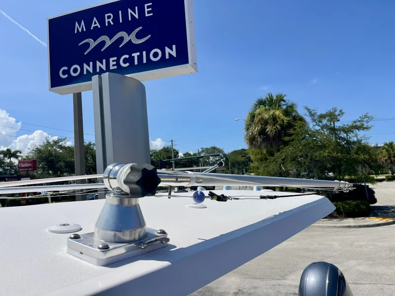 Slide: The Image of A 2022 Sea Hunt Ultra 234 boat is positioned in front of a Marine Connection sign. - 24