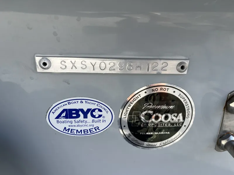 Slide: The Image of Close-up of a boat hull with serial number and stickers from ABYC and Coosa Composites. - 7