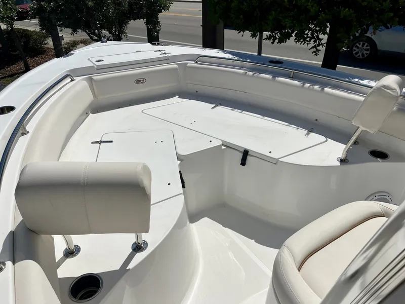 Slide: The Image of The image shows the bow area of a 2022 Sea Hunt Ultra 234 boat with white upholstery. - 16