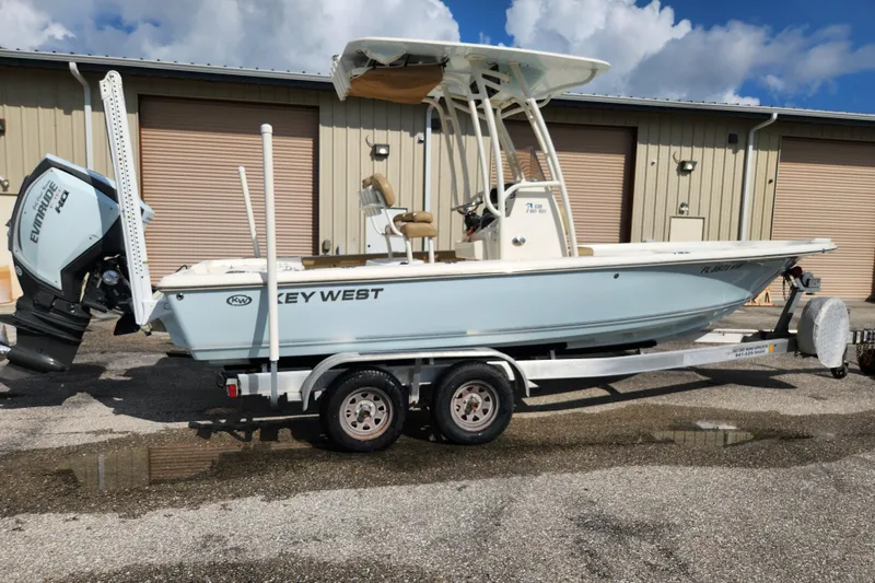 The Image of 2019 Key West 230 Bay Reef boat on trailer, parked outside a warehouse. - 0
