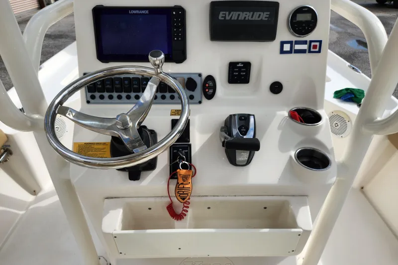 Slide: The Image of Steering console of 2019 Key West 230 Bay Reef boat with navigation controls. - 13