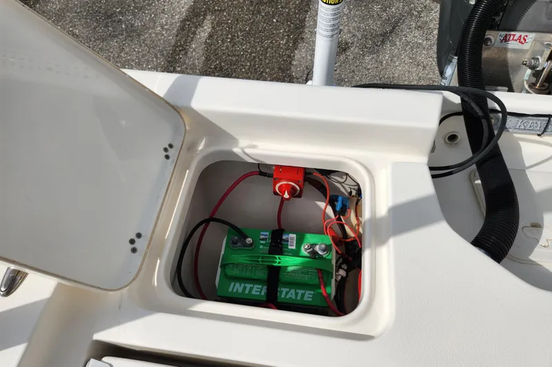 Slide: The Image of Battery compartment of a 2019 Key West 230 Bay Reef boat, featuring an Interstate battery. - 19