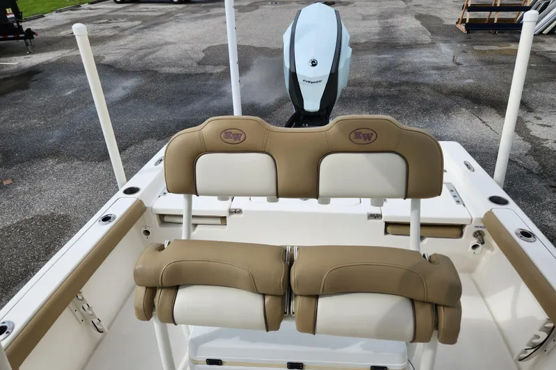 Slide: The Image of 2019 Key West 230 Bay Reef boat interior with tan seating and Evinrude motor. - 10