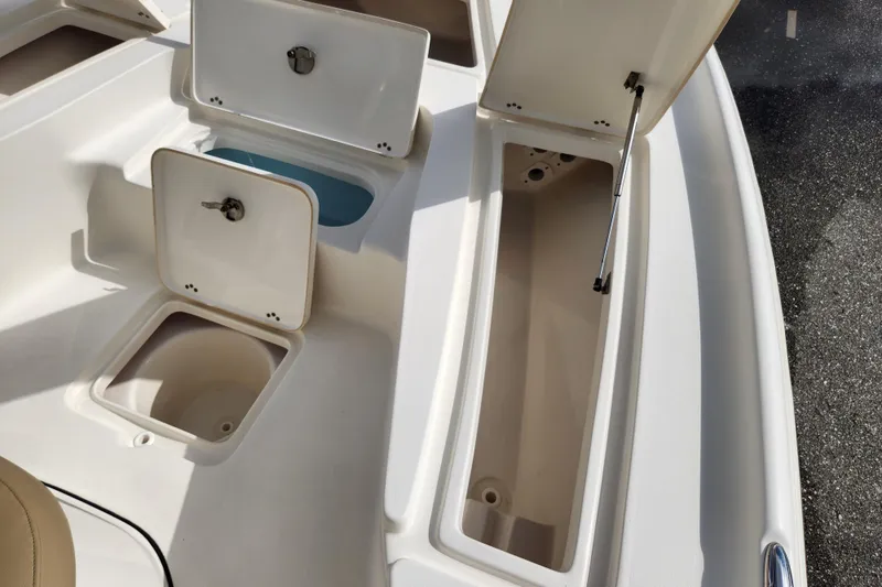 Slide: The Image of Open storage compartments on a 2019 Key West 230 Bay Reef boat deck. - 24