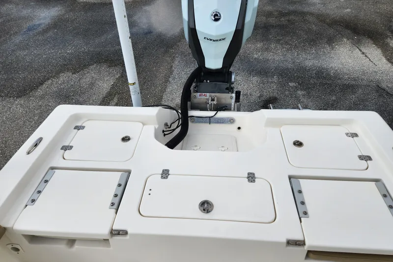 Slide: The Image of 2019 Key West 230 Bay Reef boat with Evinrude engine, featuring storage compartments. - 15