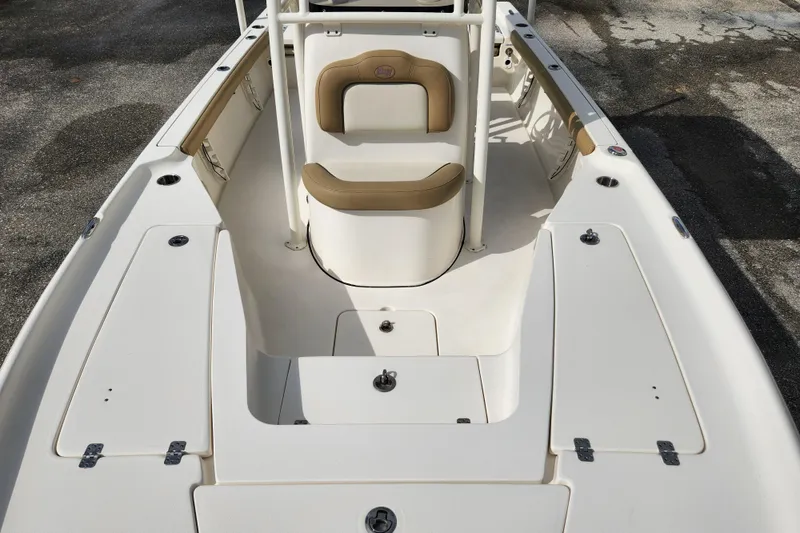 Slide: The Image of 2019 Key West 230 Bay Reef boat interior with seating and storage compartments. - 6