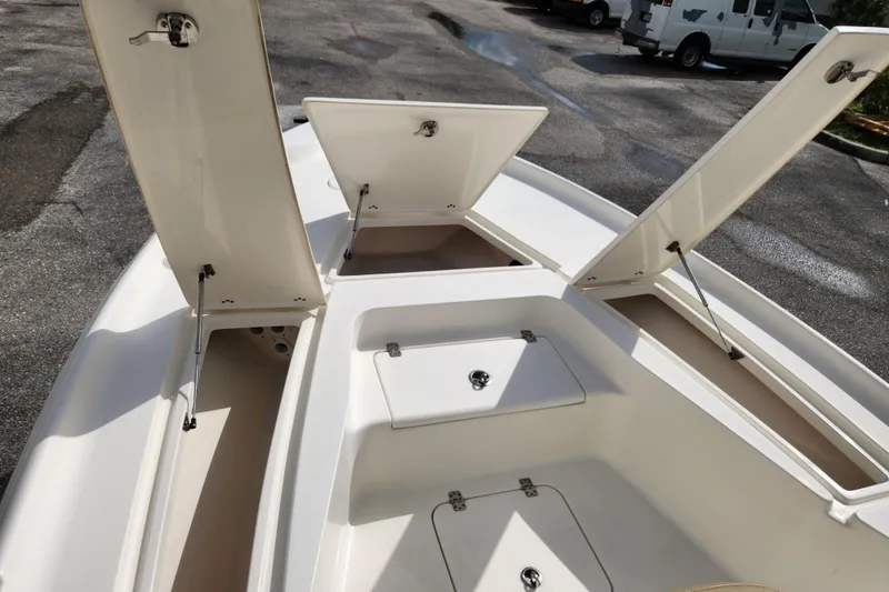 Slide: The Image of 2019 Key West 230 Bay Reef boat with open storage compartments on deck. - 28