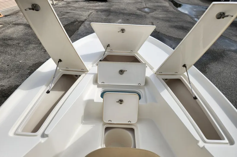 Slide: The Image of 2019 Key West 230 Bay Reef boat storage compartments open on deck. - 21