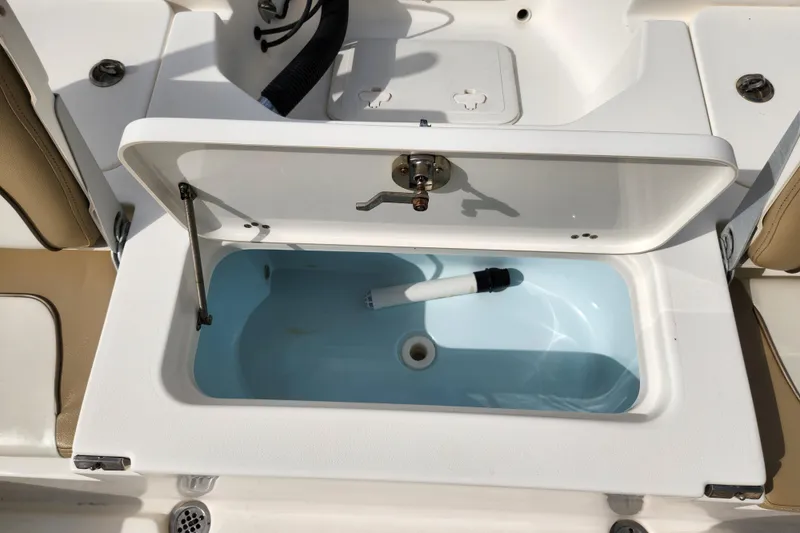 Slide: The Image of Open storage compartment on 2019 Key West 230 Bay Reef boat, featuring a clean interior. - 17