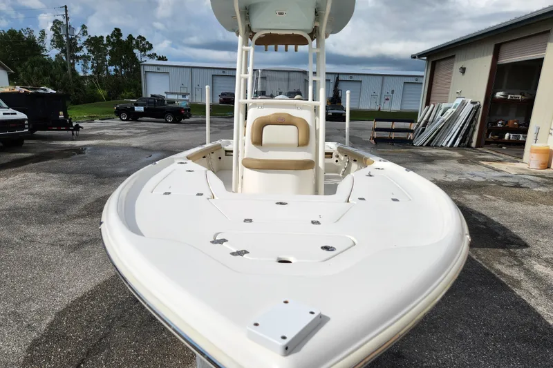 Slide: The Image of 2019 Key West 230 Bay Reef boat in a storage yard, showcasing its spacious deck. - 5