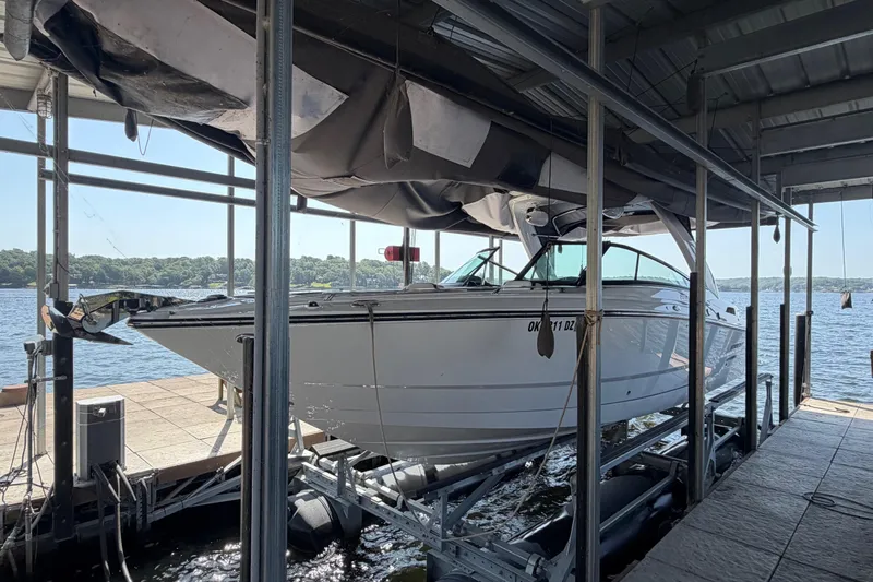 The Image of 2020 Monterey 298SS Super Sport boat docked on a lift by the lake. - 1