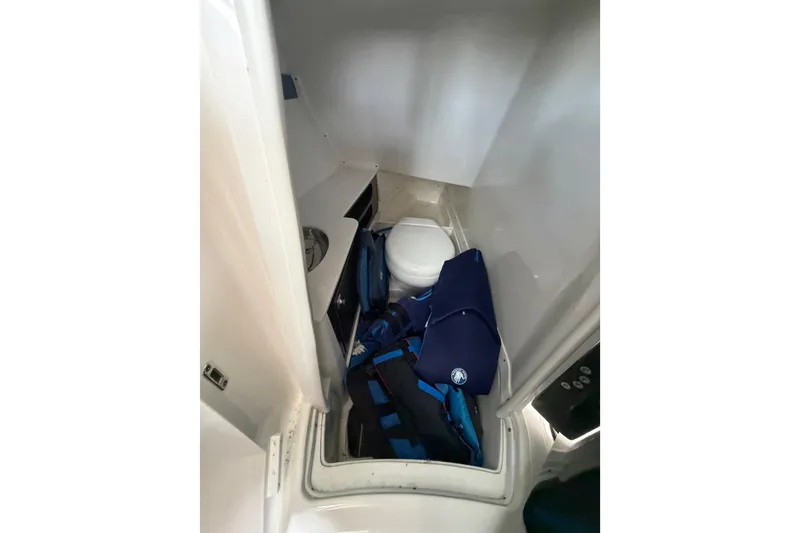 Slide: The Image of Interior of 2020 Monterey 298SS Super Sport boat with compact toilet and storage area. - 12