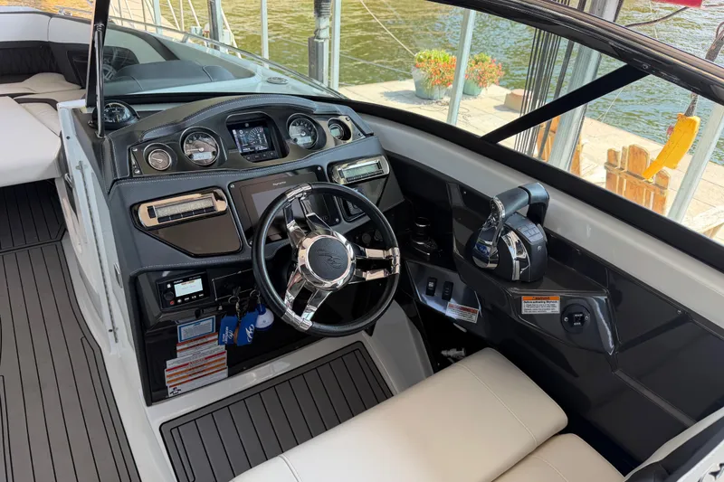 Slide: The Image of Cockpit of 2020 Monterey 298SS Super Sport boat with modern controls and steering wheel. - 8