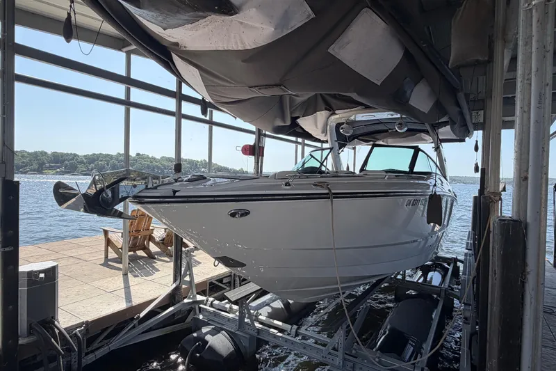 Slide: The Image of 2020 Monterey 298SS Super Sport boat docked in a marina with scenic lake view. - 13