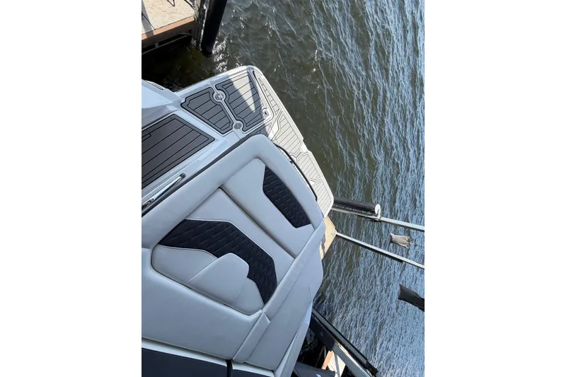 Slide: The Image of 2020 Monterey 298SS Super Sport boat docked by the water. - 5