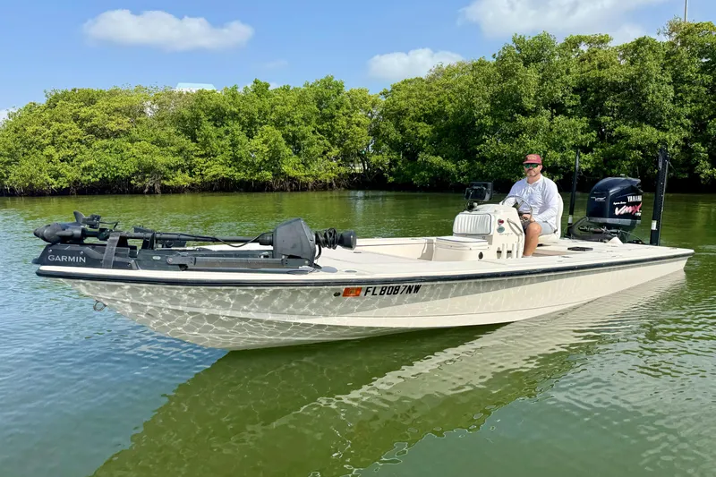 Slide: The Image of 2007 Hewes Redfisher 21 boat on calm water, featuring Garmin equipment and Yamaha engine. - 3
