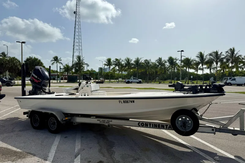 Slide: The Image of 2007 Hewes Redfisher 21 boat on trailer in sunny parking lot with palm trees. - 26