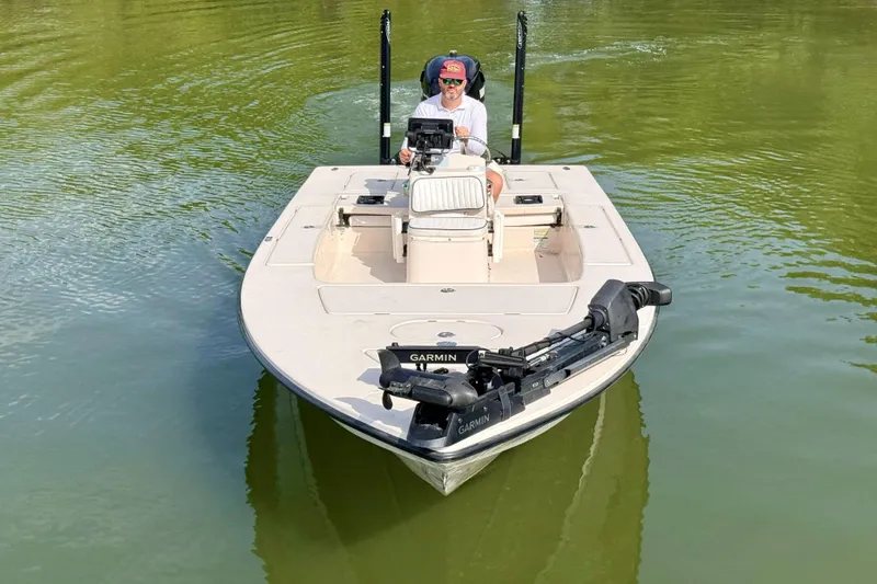 Slide: The Image of 2007 Hewes Redfisher 21 boat on calm water, featuring Garmin equipment. - 5