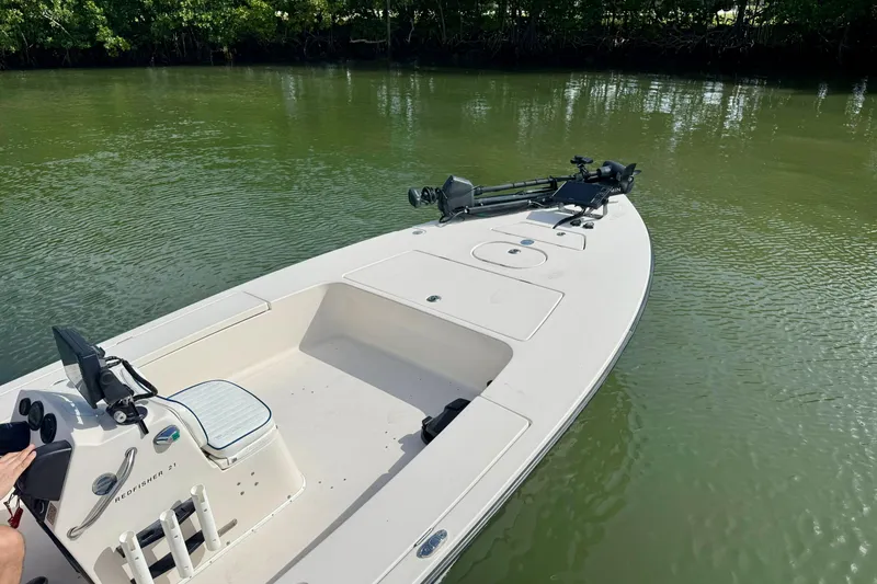 Slide: The Image of 2007 Hewes Redfisher 21 boat on calm water, featuring a sleek design and fishing equipment. - 7