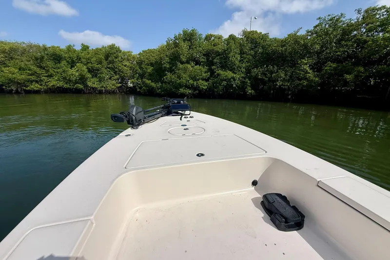 Slide: The Image of 2007 Hewes Redfisher 21 boat on calm water near lush green mangroves. - 20