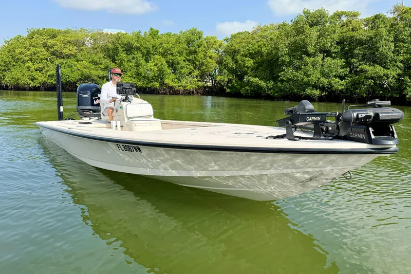Slide: The Image of 2007 Hewes Redfisher 21 boat on calm water, equipped with Garmin technology. - 1