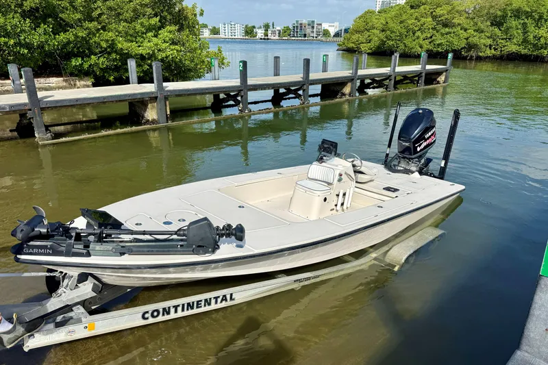 Slide: The Image of 2007 Hewes Redfisher 21 boat on trailer by dock, featuring Garmin equipment. - 28
