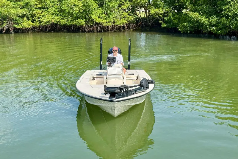 Slide: The Image of 2007 Hewes Redfisher 21 boat navigating through calm, green waters near lush mangroves. - 4