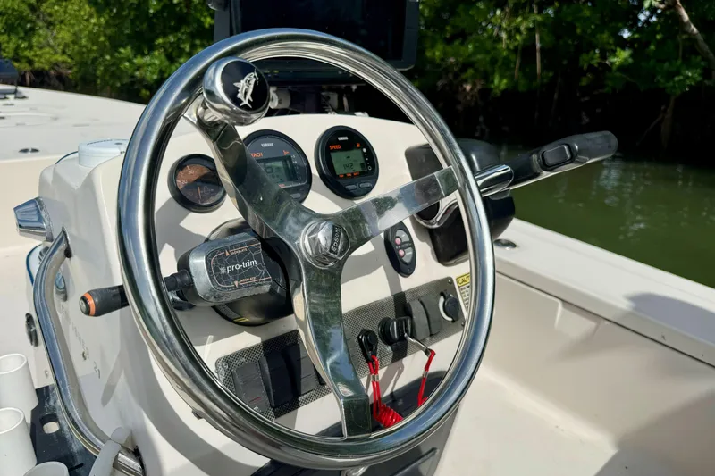 Slide: The Image of Steering console of a 2007 Hewes Redfisher 21 boat with gauges and controls. - 11