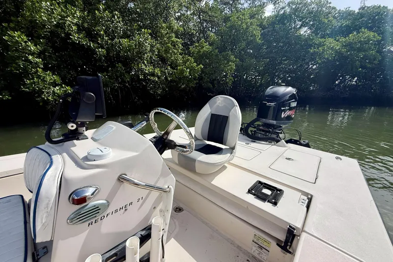 Slide: The Image of 2007 Hewes Redfisher 21 boat with Yamaha engine, docked near lush mangroves. - 14