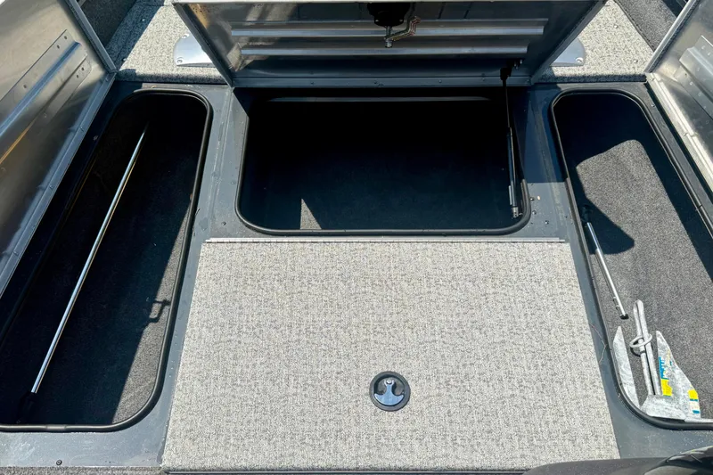 Slide: The Image of 2021 Tracker Pro Team 175 TF boat storage compartments with open hatches and visible anchor. - 8