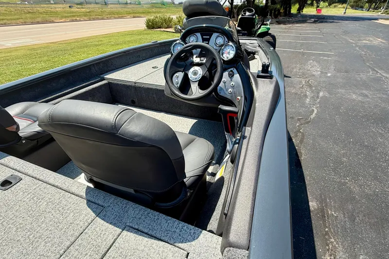 Slide: The Image of 2021 Tracker Pro Team 175 TF boat interior with steering wheel and seating. - 2