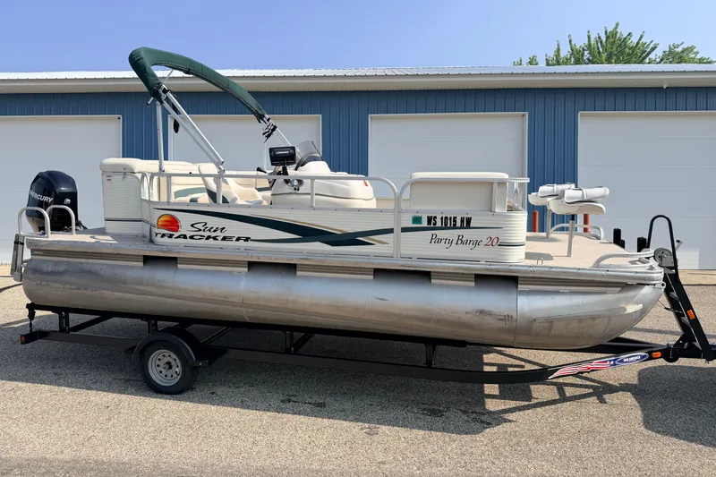Slide: The Image of 2010 Sun Tracker Party Barge 20 Classic pontoon boat on trailer, parked outdoors. - 3