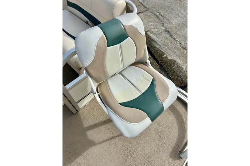 Slide: The Image of 2010 Sun Tracker Party Barge 20 Classic Series boat seat with beige and green upholstery. - 34