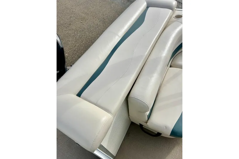 Slide: The Image of 2010 Sun Tracker Party Barge 20 Classic Series boat seating, featuring white and teal upholstery. - 27