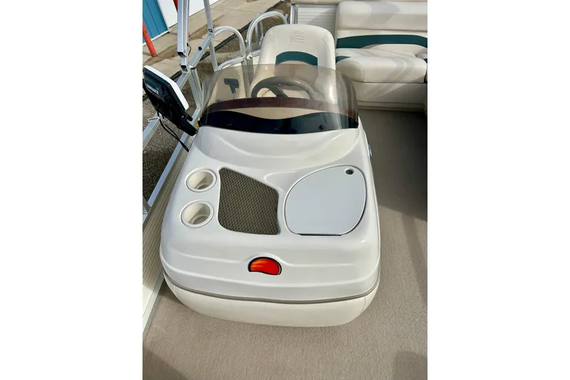 Slide: The Image of 2010 Sun Tracker Party Barge 20 Classic Series helm with steering wheel and cup holders. - 21