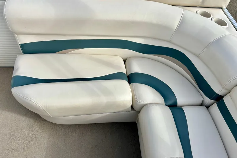 Slide: The Image of 2010 Sun Tracker Party Barge 20 Classic Series boat seating with teal accents and cup holders. - 25