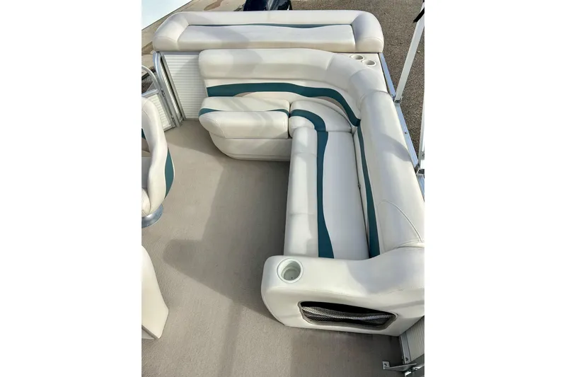 Slide: The Image of 2010 Sun Tracker Party Barge 20 Classic Series interior seating with white and teal upholstery. - 22