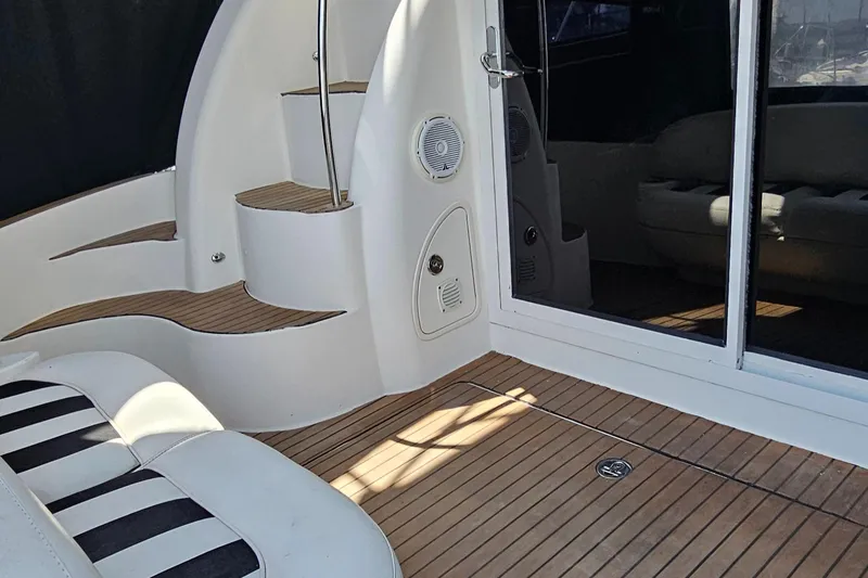 Slide: The Image of 2007 Meridian 341 Sedan yacht interior with striped seating and wooden flooring. - 15